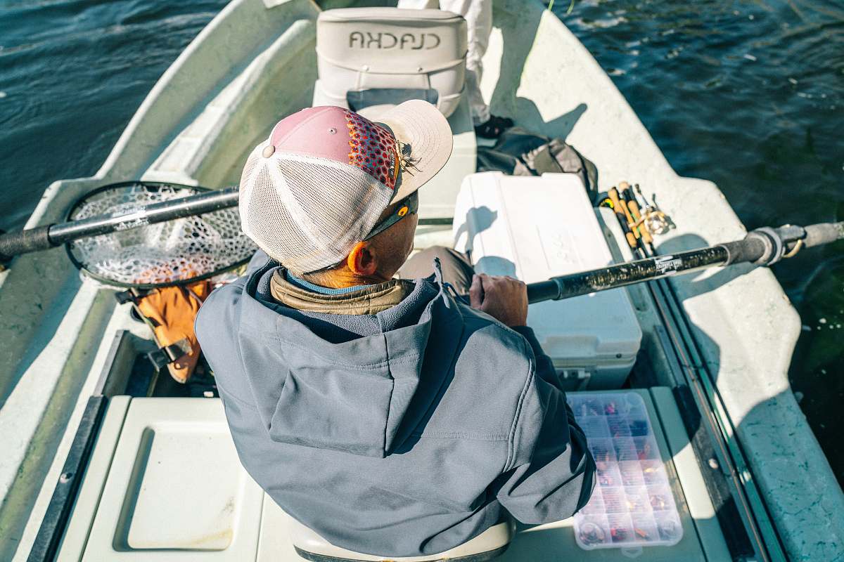 north platte river man wearing jacket and cap riding boat oar